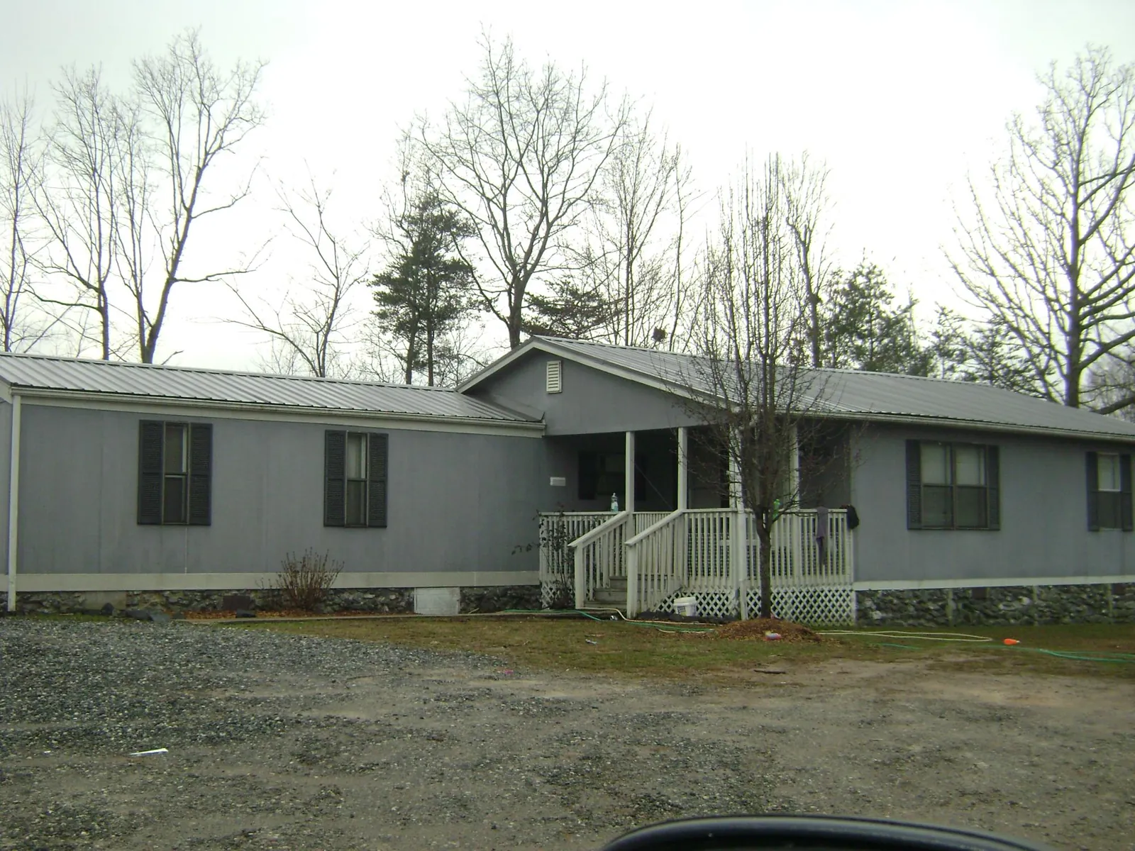 Metal roof over a manufactured home with a covered front porch in Woodridge